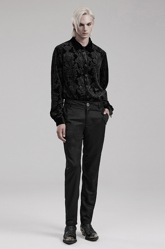 Elegant black velvet gothic shirt with floral embossing, worn by model against a minimalist backdrop.