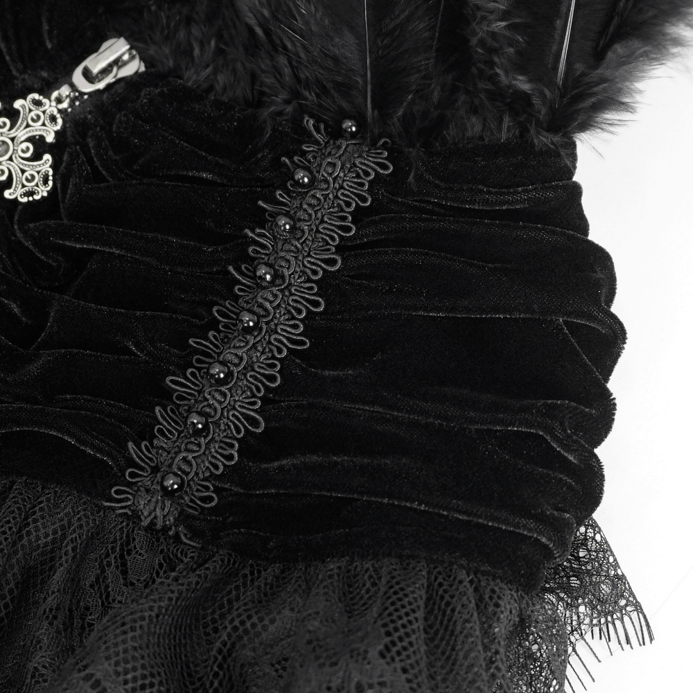 Close-up of black velvet gothic cape showing lace and feather details, perfect for costumes and Halloween.