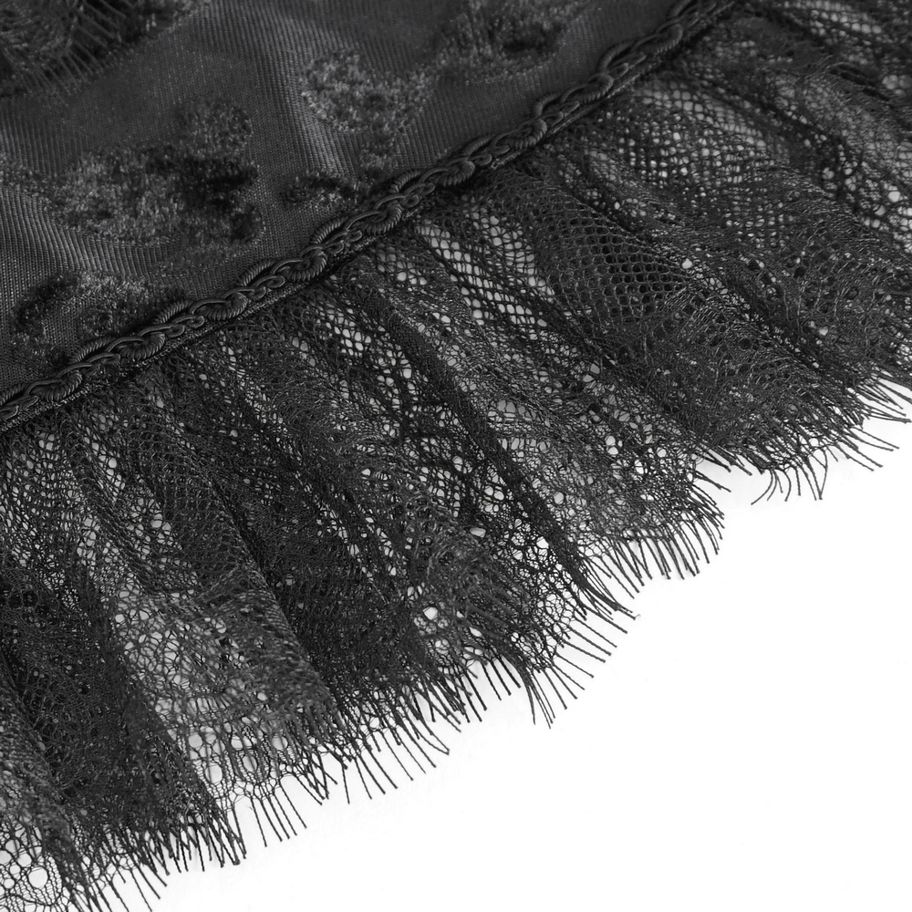 Close-up of black lace trim with delicate feathers for a gothic cape, showcasing intricate details and elegance.