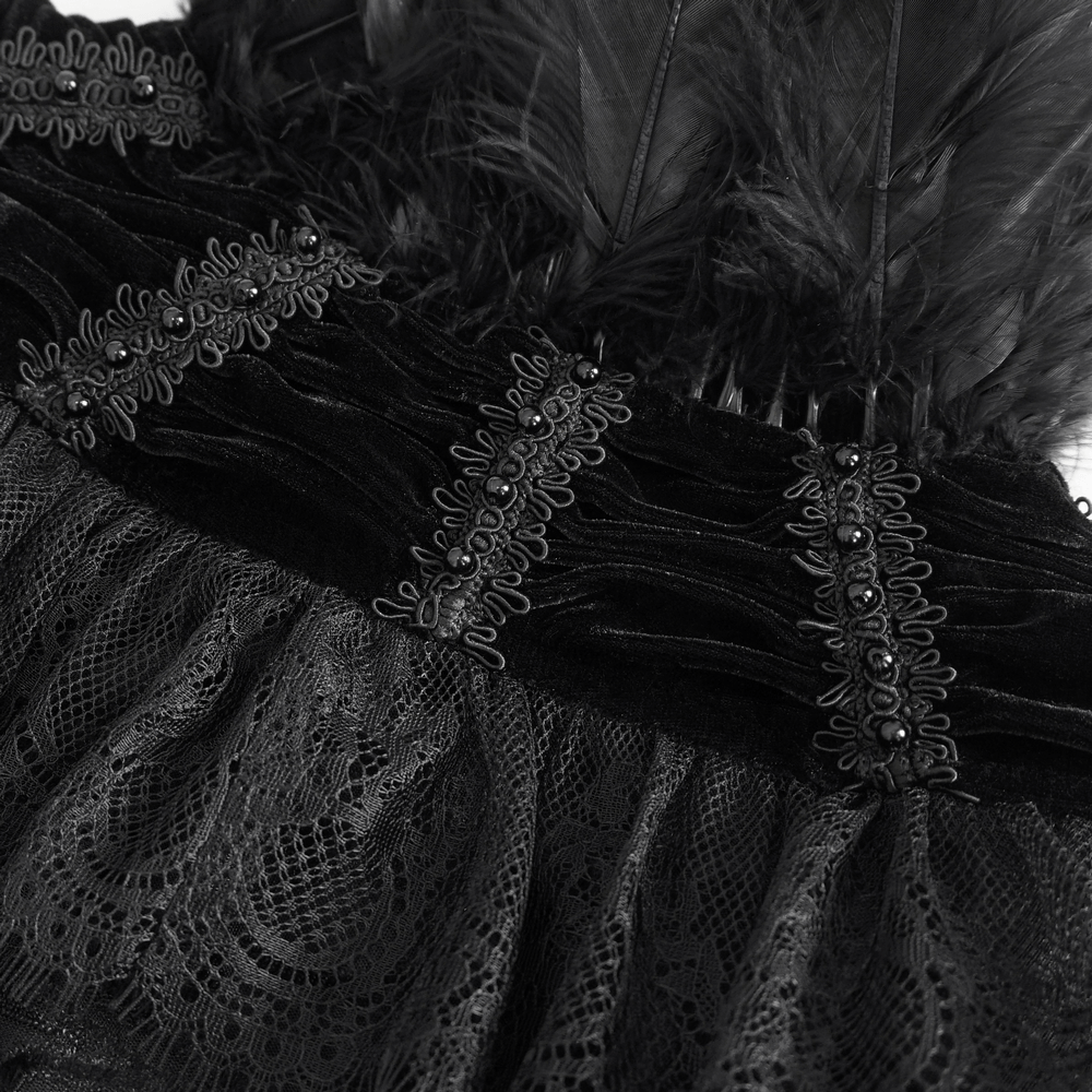 Close-up of black velvet cape with lace trim and feathers detailing, perfect for gothic costumes.