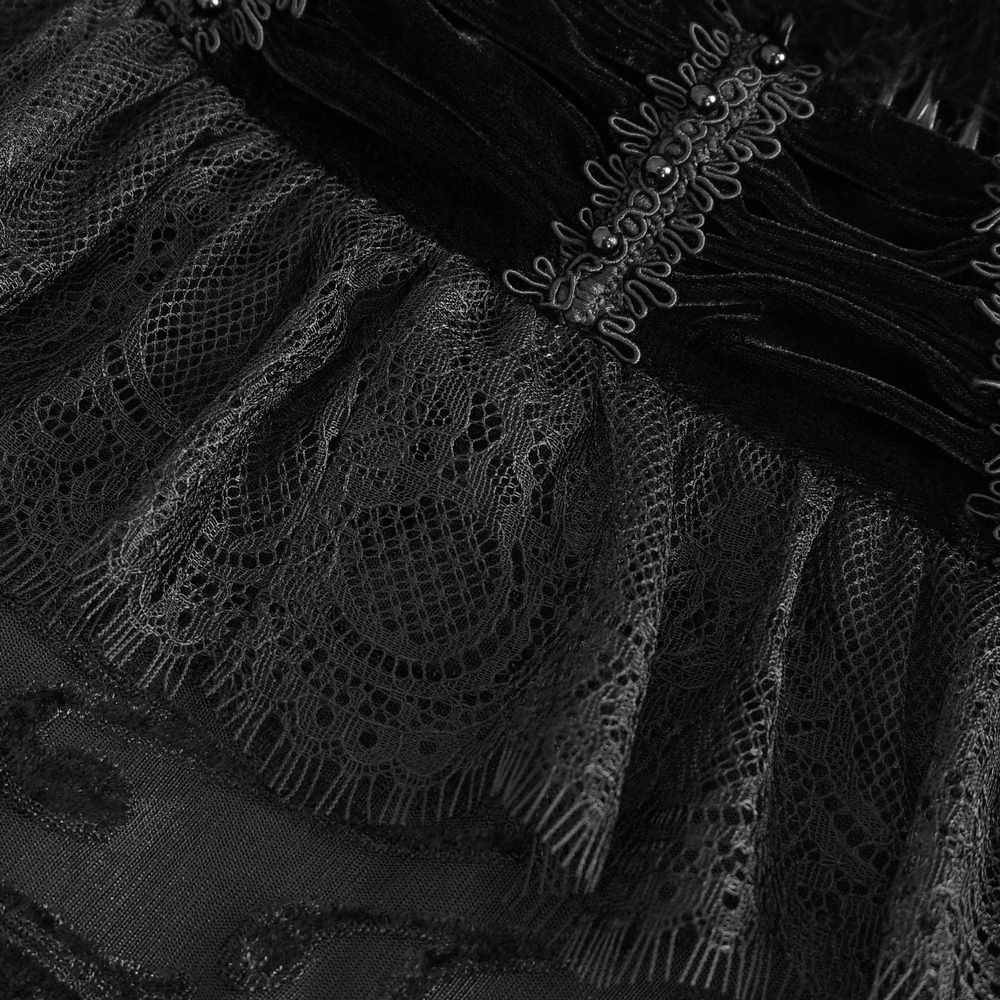 Close-up of elegant black lace and velvet fabric with delicate ruffles and intricate details of a gothic cape.