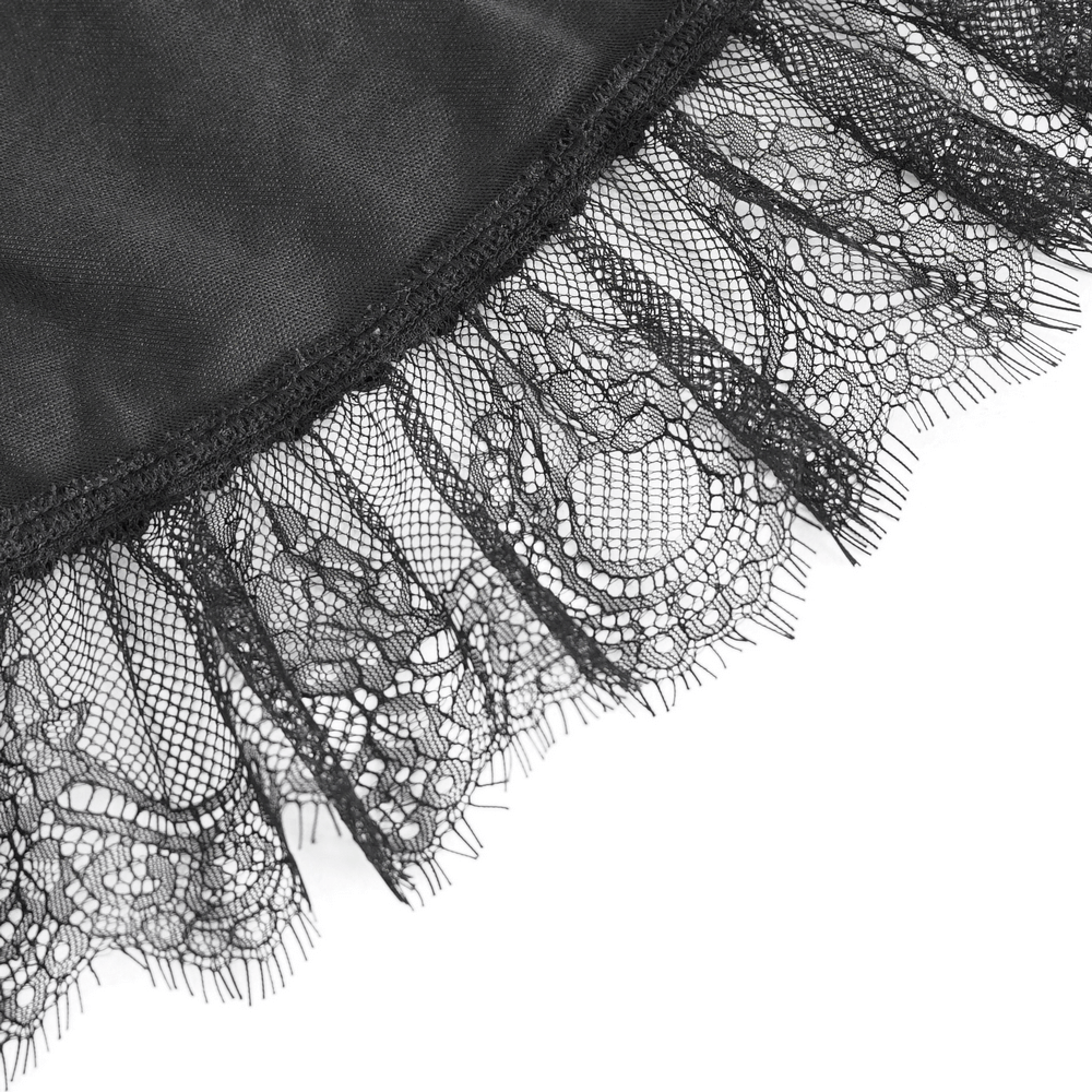 Close-up of intricate black lace trim on a gothic cape, showcasing elegant details and dramatic flair.