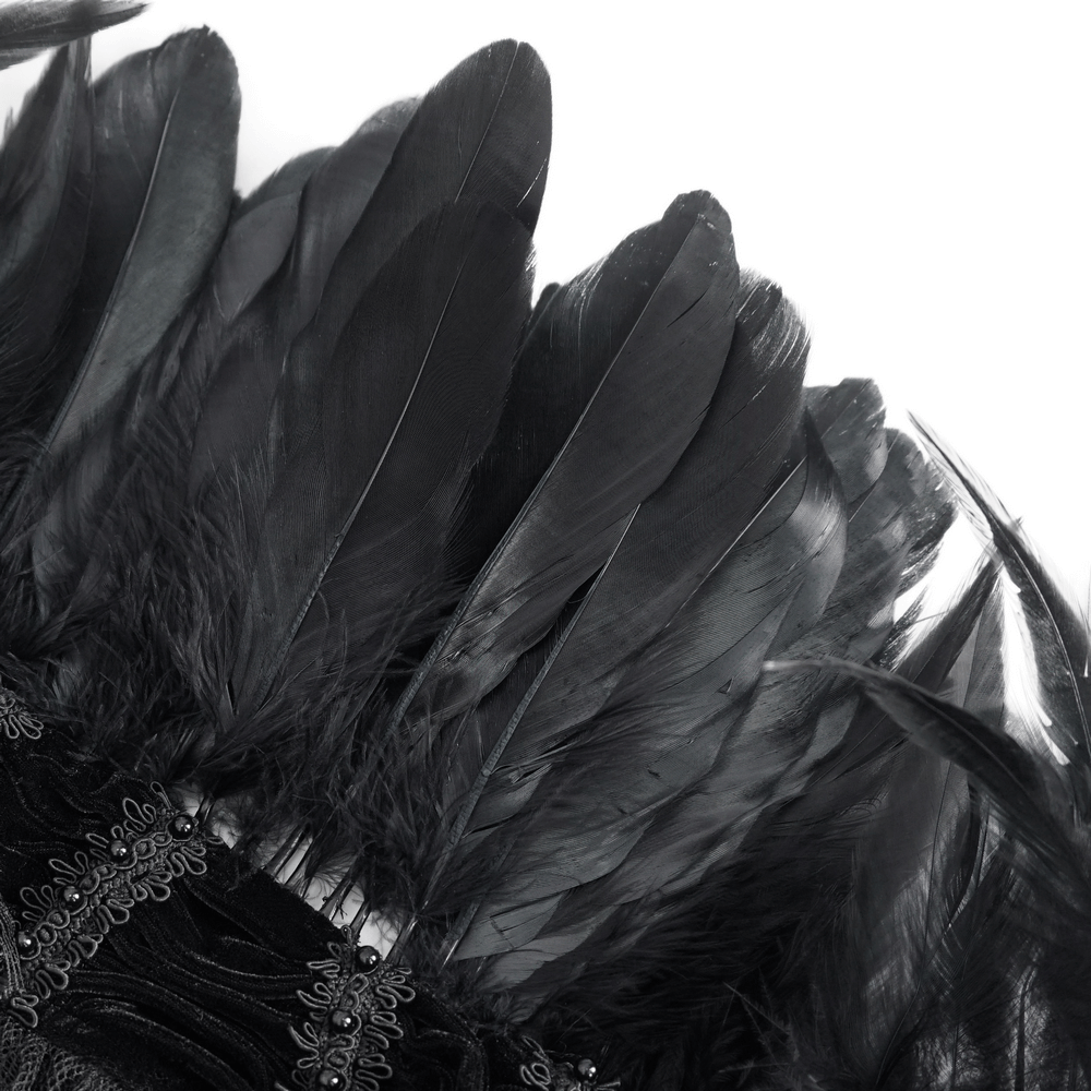 Close-up of black feathers and lace trim from a gothic cape, perfect for costumes and Halloween.