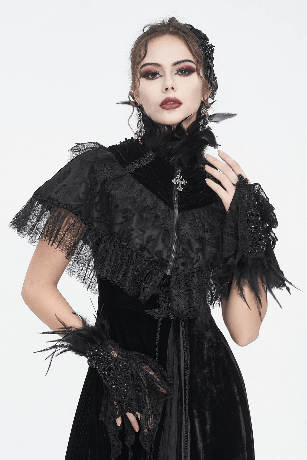 Elegant model wearing a black velvet gothic cape with lace and feathers, perfect for Halloween and cosplay.