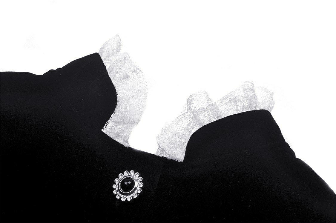 Close-up of black velvet coat with white lace collar and cuffs, showcasing elegant gothic style details.