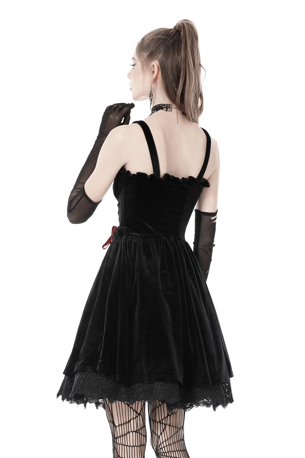 Back view of a black velvet gothic mini dress, featuring a flattering silhouette and lace details for dark romantics.