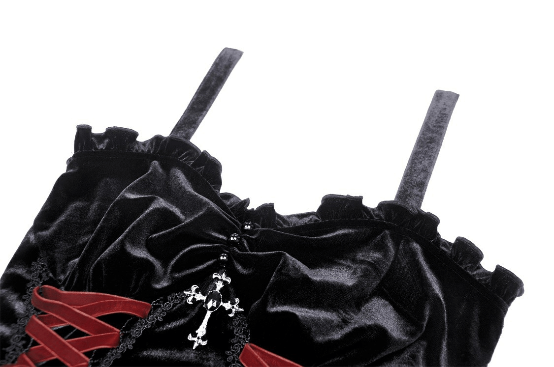 Close-up of black velvet gothic mini dress featuring cross detail and ruffled straps, perfect for dark romantics.