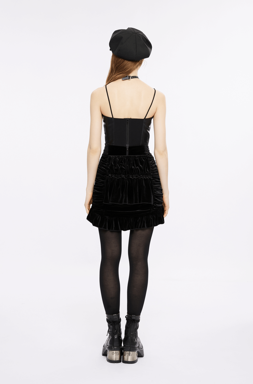 Black velvet gothic mini skirt with lace waist, ruffled hem, and adjustable sides, styled with a black top and beret.