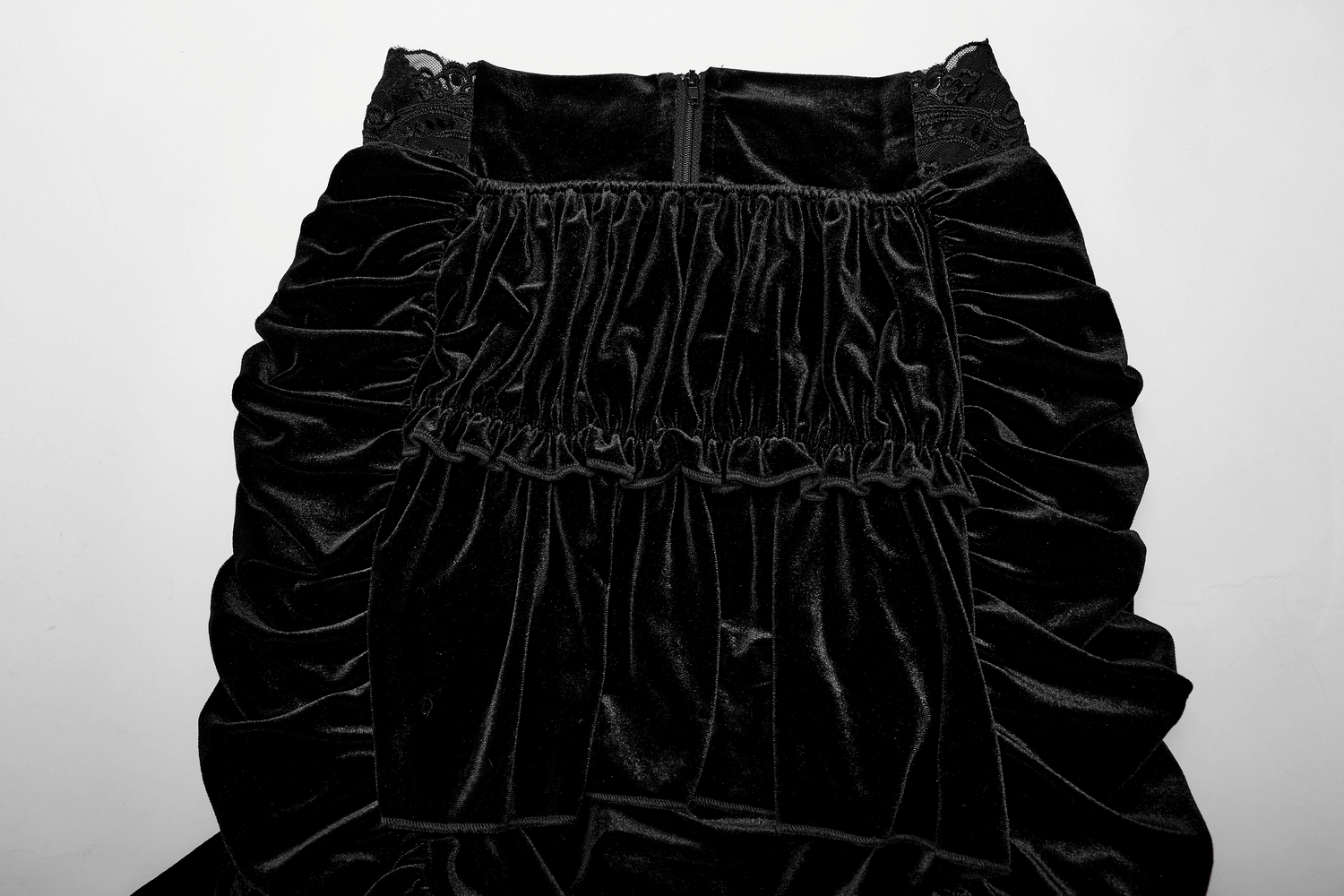 Black velvet gothic mini skirt with lace waist and ruffled design, perfect for a Victorian-inspired ensemble.