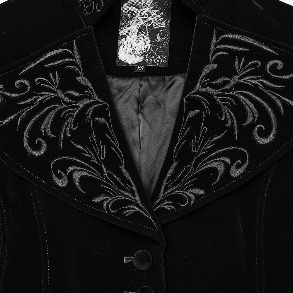 Close-up of black velvet gothic tailcoat collar with intricate embroidery, showcasing stylish buttons and elegant texture.