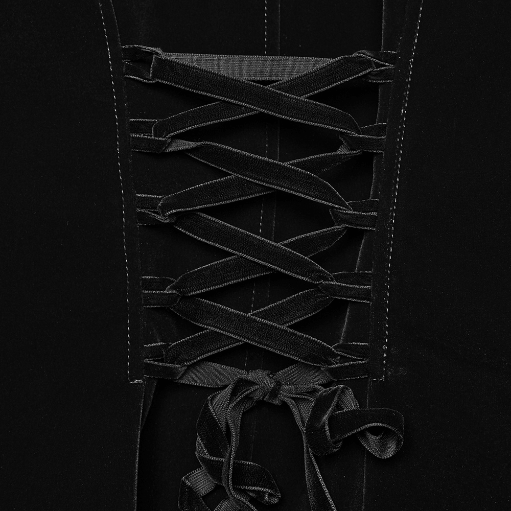 Close-up of black velvet Gothic tailcoat with lace-up corset waist detail and textured fabric design.