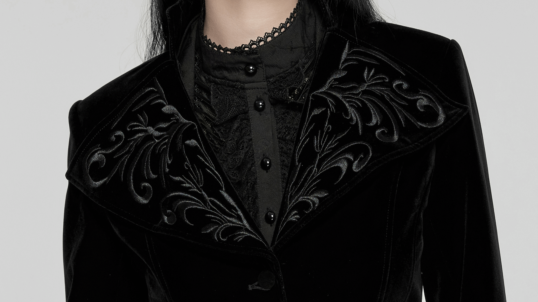 Black velvet gothic tailcoat with embroidered collar, showcasing rich fabric and detailed design.