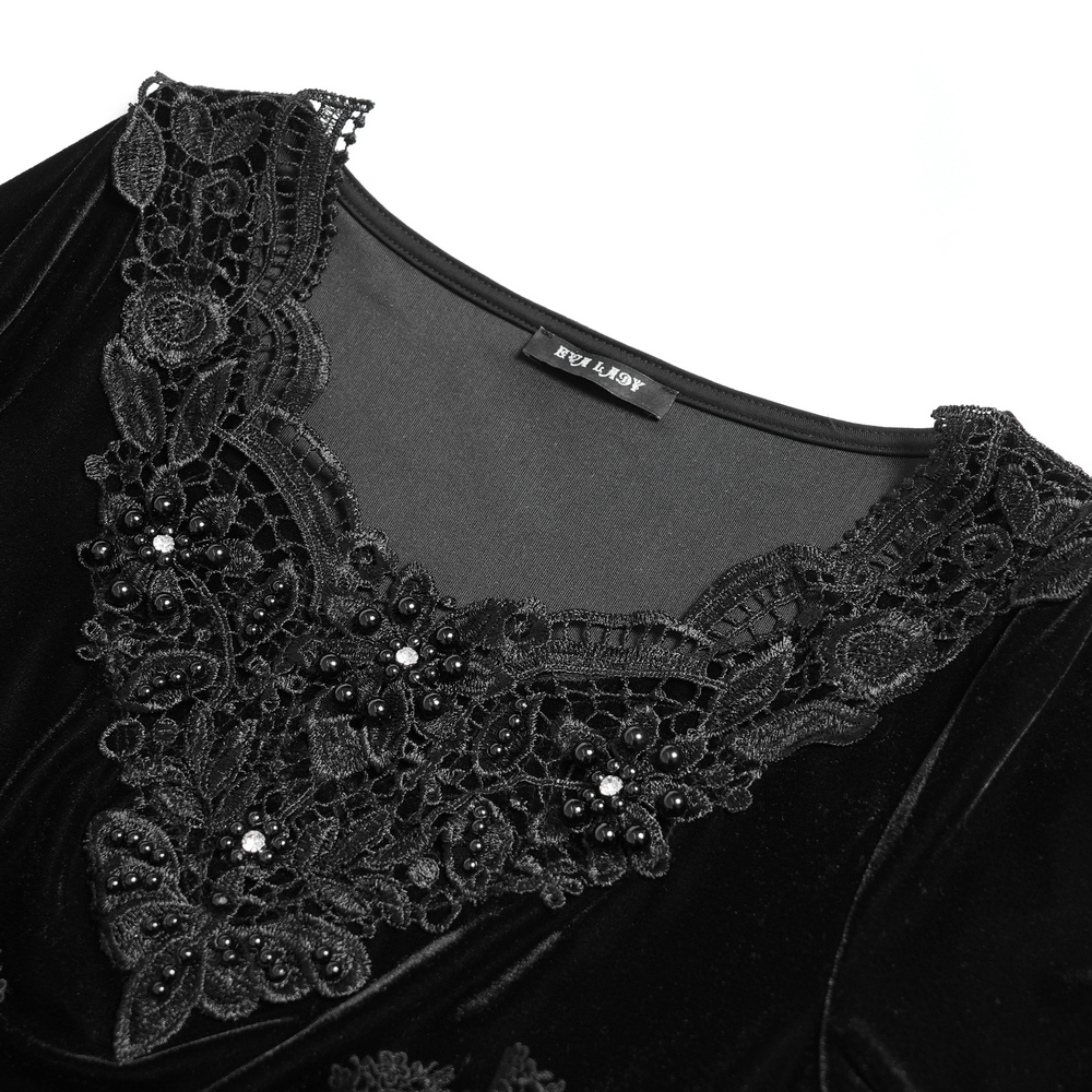 Close-up of black velvet gothic top with Victorian lace trim and beaded details, perfect for stylish evening wear.