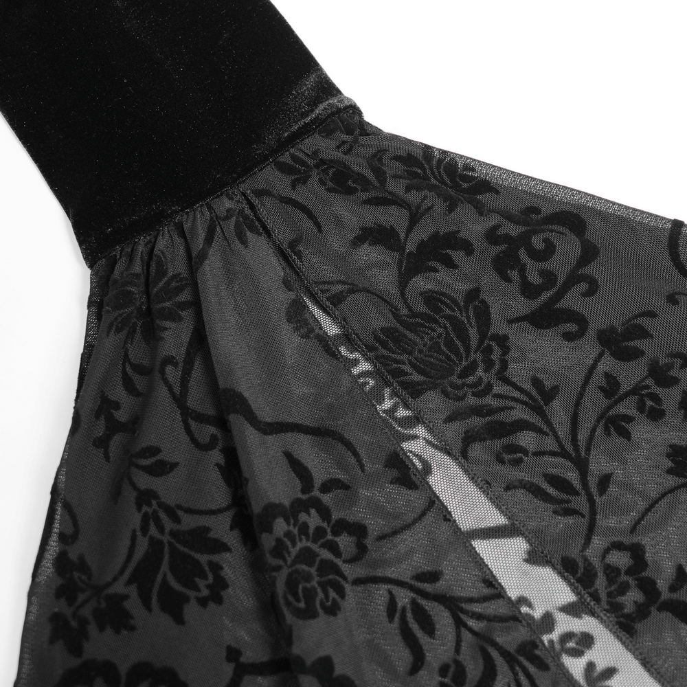 Detail of black velvet top featuring sheer flared sleeves with intricate floral patterns and lace trim.