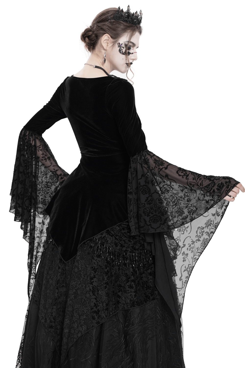 Model showcasing a black velvet gothic top with lace sleeves and corset details, perfect for Victorian-inspired fashion.