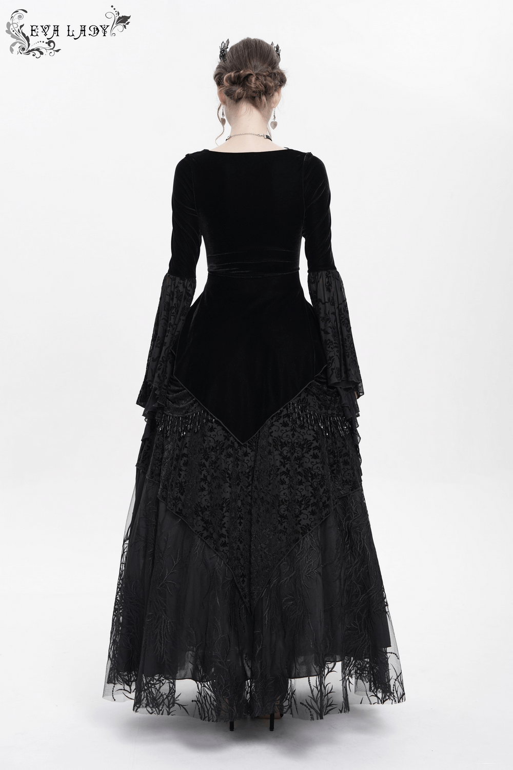 Back view of a gothic black velvet dress with sheer lace sleeves and intricate floral details.