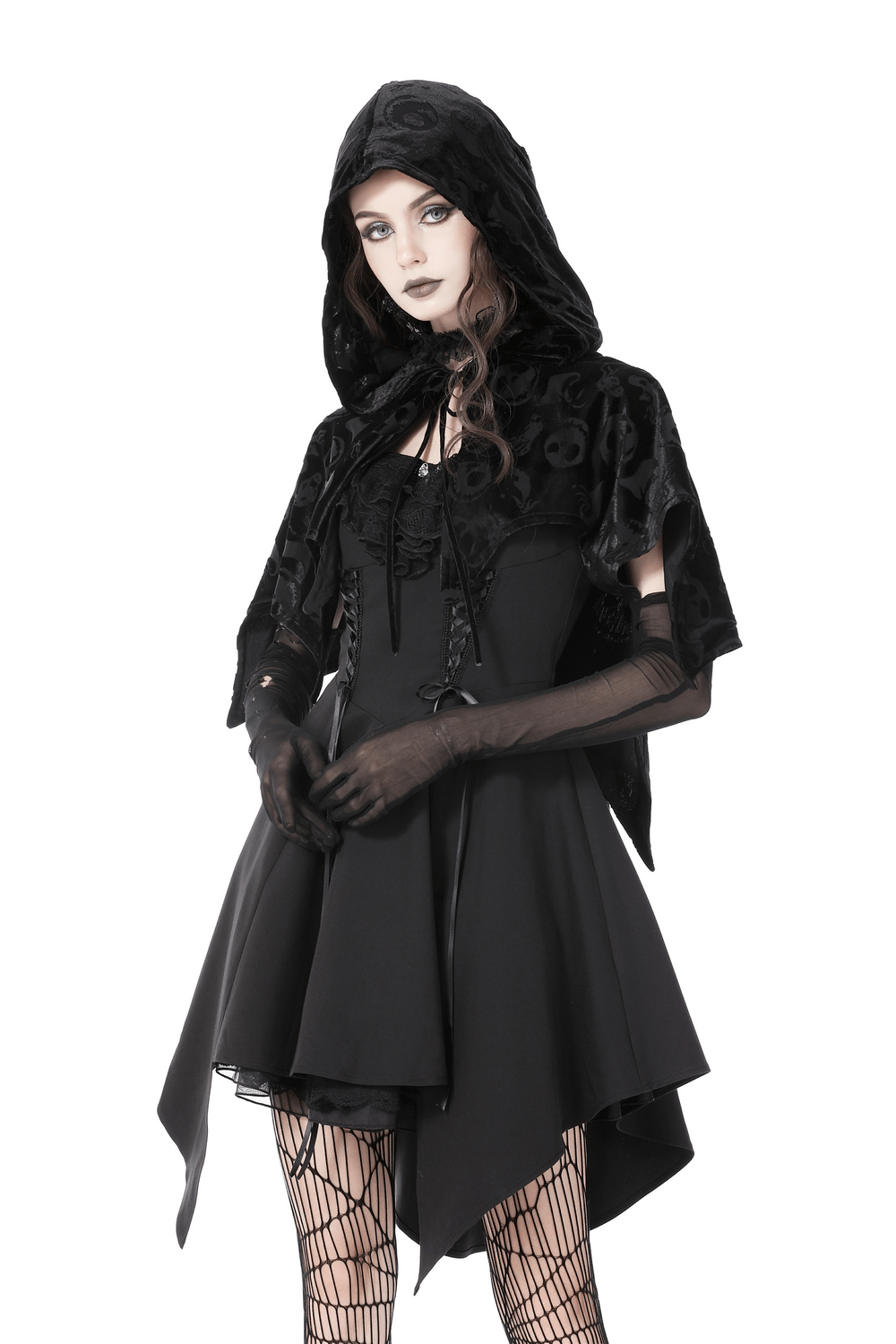 Gothic black velvet hooded cape with skull print, styled with a chic black dress and fishnet gloves.
