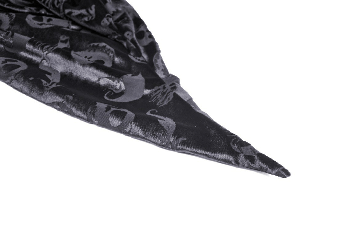 Close-up of black velvet hooded cape with skull print design, perfect for gothic costumes and Halloween.