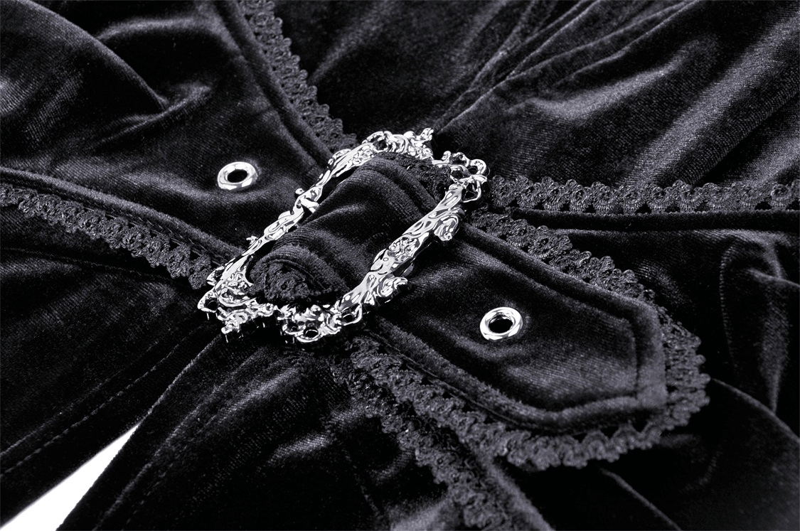 Close-up of luxurious black velvet cloak detailing with ornate clasp and lace trim.