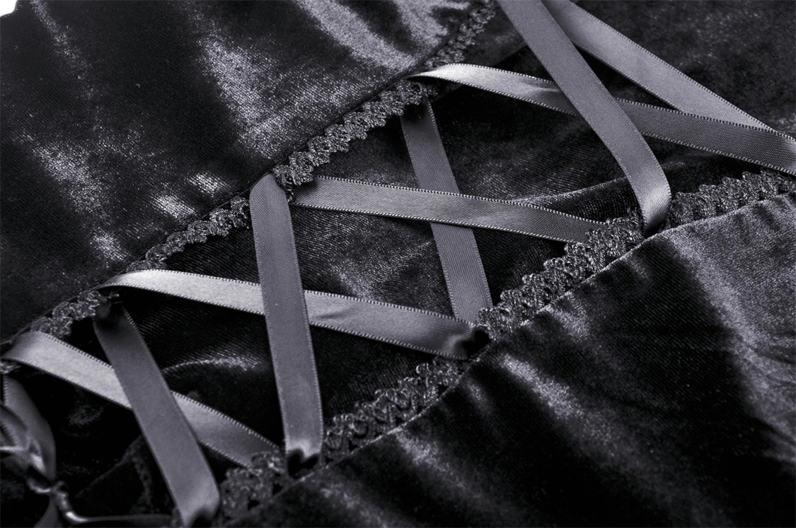 Close-up of black velvet fabric with delicate lace and satin ribbon detailing, perfect for a gothic hooded cloak.