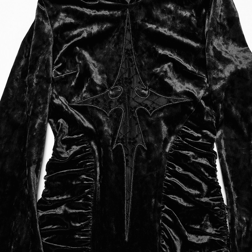 Close-up of the elegant black velvet dress featuring intricate lace cross design and ruched details.