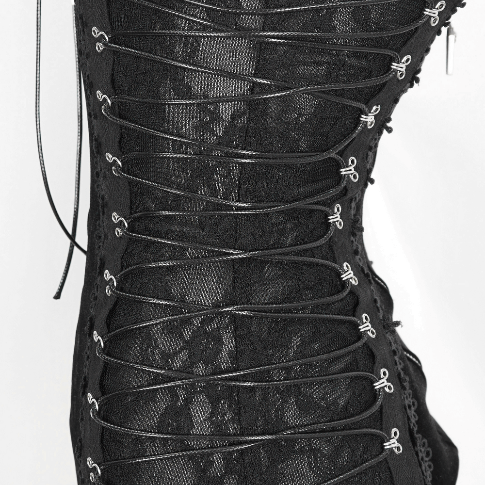 Close-up of a black velvet bodysuit with intricate lace-up detailing and delicate lace accents.