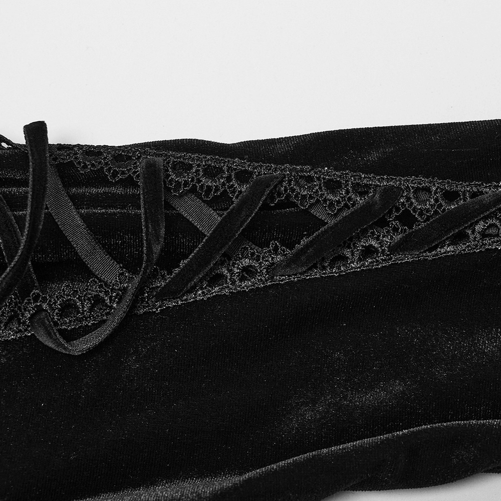 Close-up of black lace straps and velvet fabric on a gothic dress, showcasing intricate detailing and texture.