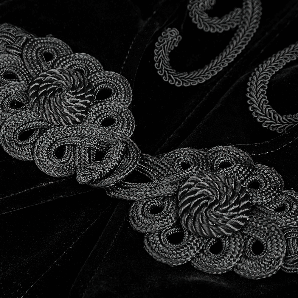 Intricate black embroidery detailing on a Gothic long coat, showcasing vintage craftsmanship and elegant design.
