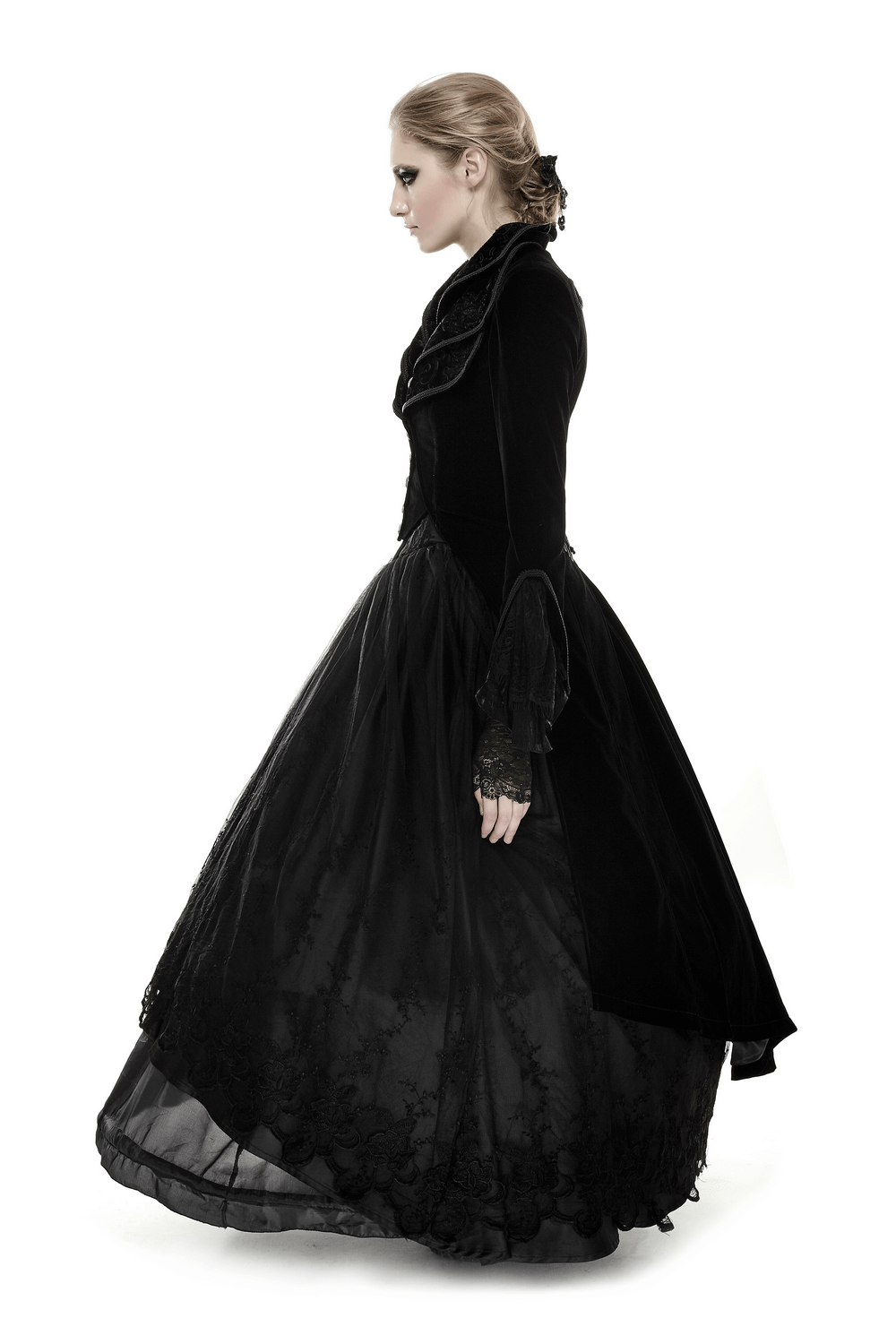 Black velvet long gothic trench coat with cascading collar worn by a model, showcasing its elegance and intricate design.