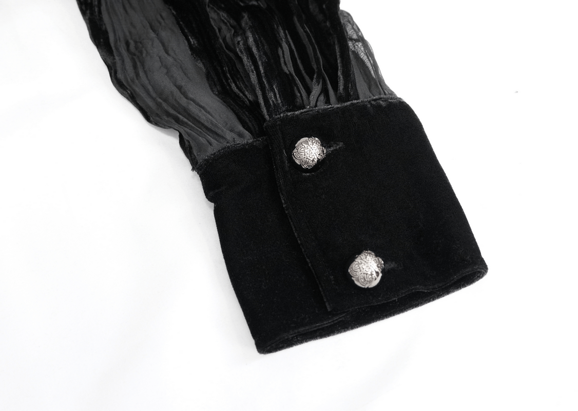 Close-up of black velvet shirt cuff featuring silver buttons and transparent fabric for a gothic elegant look.