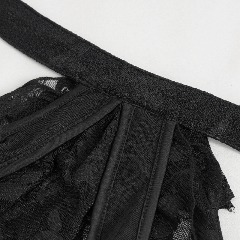 Close-up of black lace ruffle and bowtie strap on a vintage gothic one-piece swimsuit.