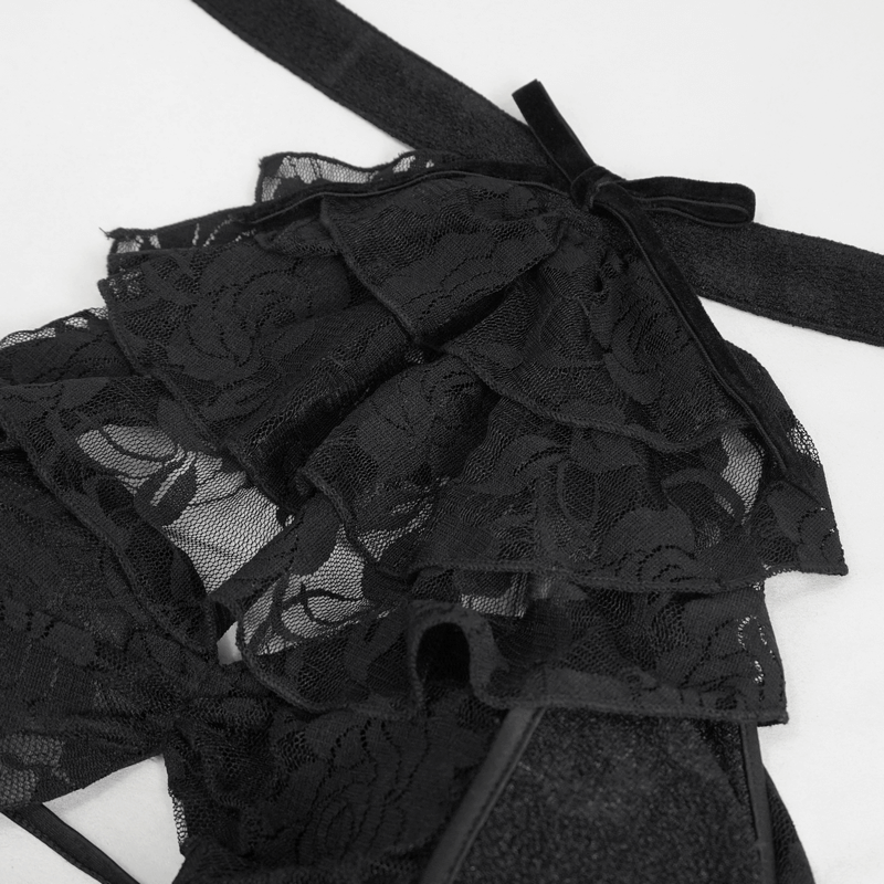 Close-up of black lace ruffles on a vintage gothic swimsuit, featuring chic bowtie detail.