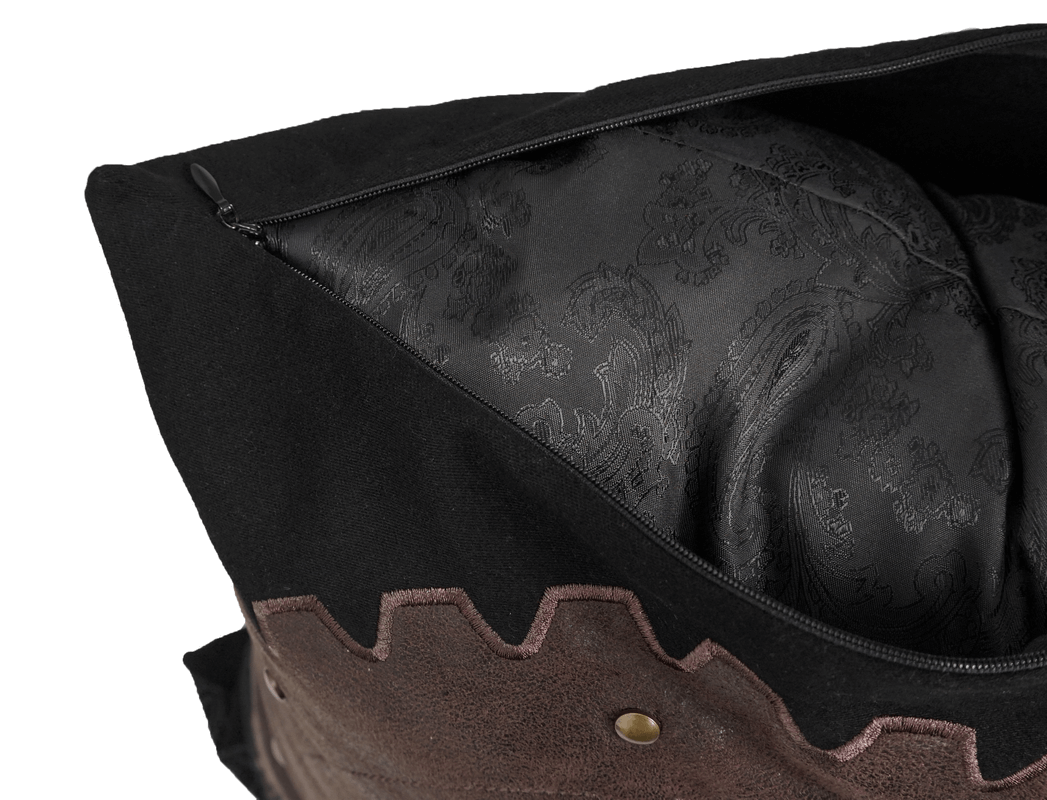 Close-up of black vintage pillow with brown cracked leather and zipper, showcasing the elegant inner fabric design.