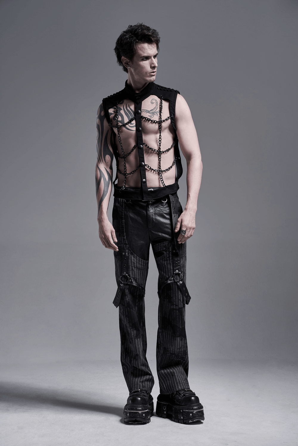 Model wearing Black Warlock Chain Waistcoat Punk Rave style, showcasing edgy design and tattoos.