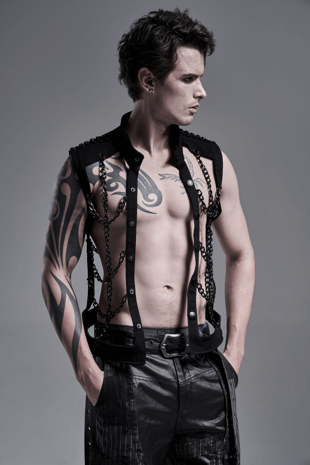 Stylish male model wearing a Black Warlock Chain Waistcoat with tattoo and punk rave aesthetic.