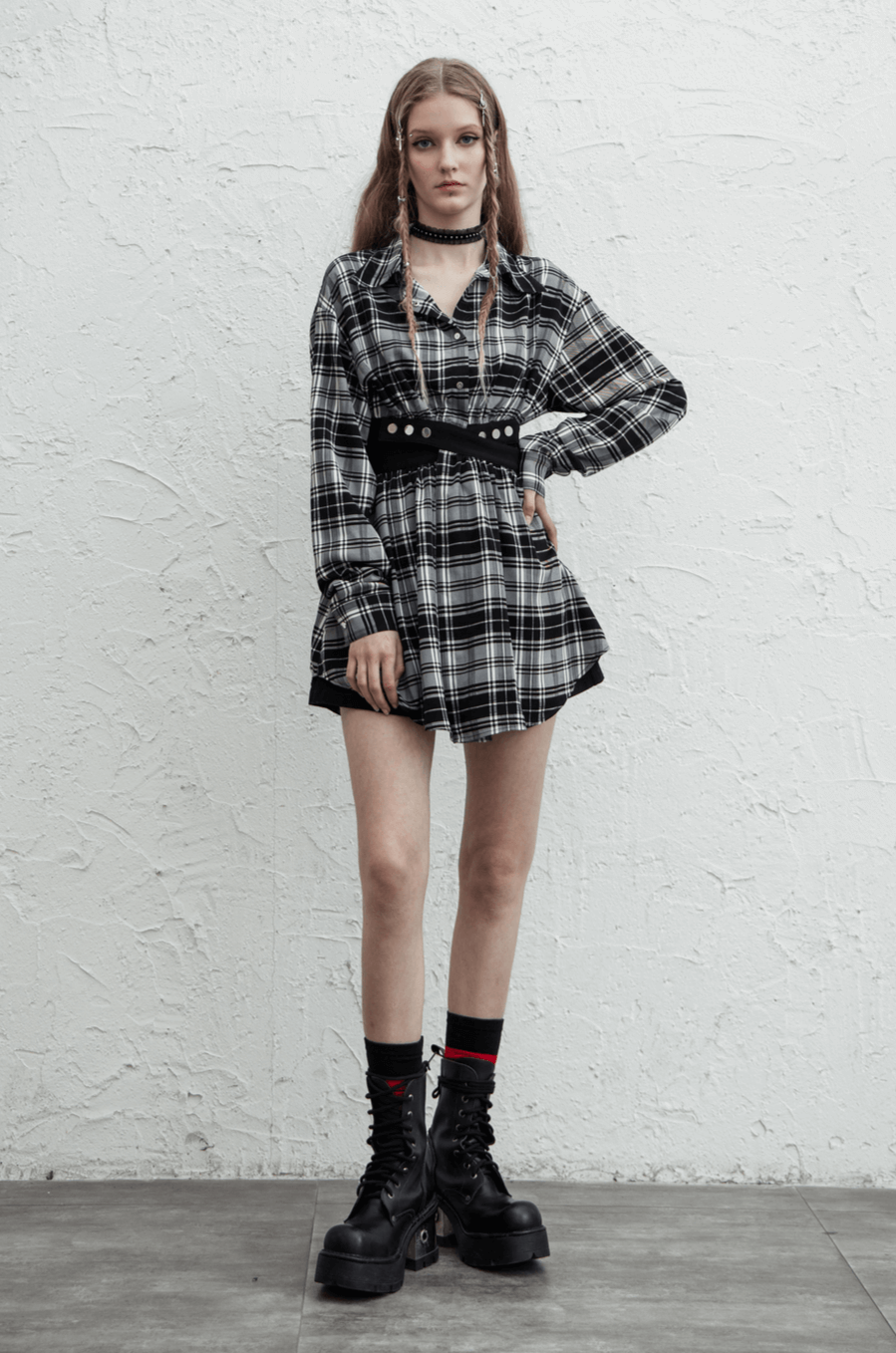 Model wearing a black and white plaid punk gothic detachable dress with a waist cut-out and buckle accents.