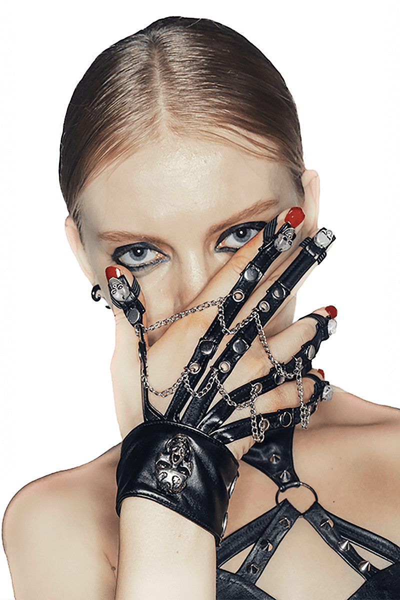 Gothic black women's gloves with chains and skulls, stylishly worn by a model, adding flair to dark fashion.