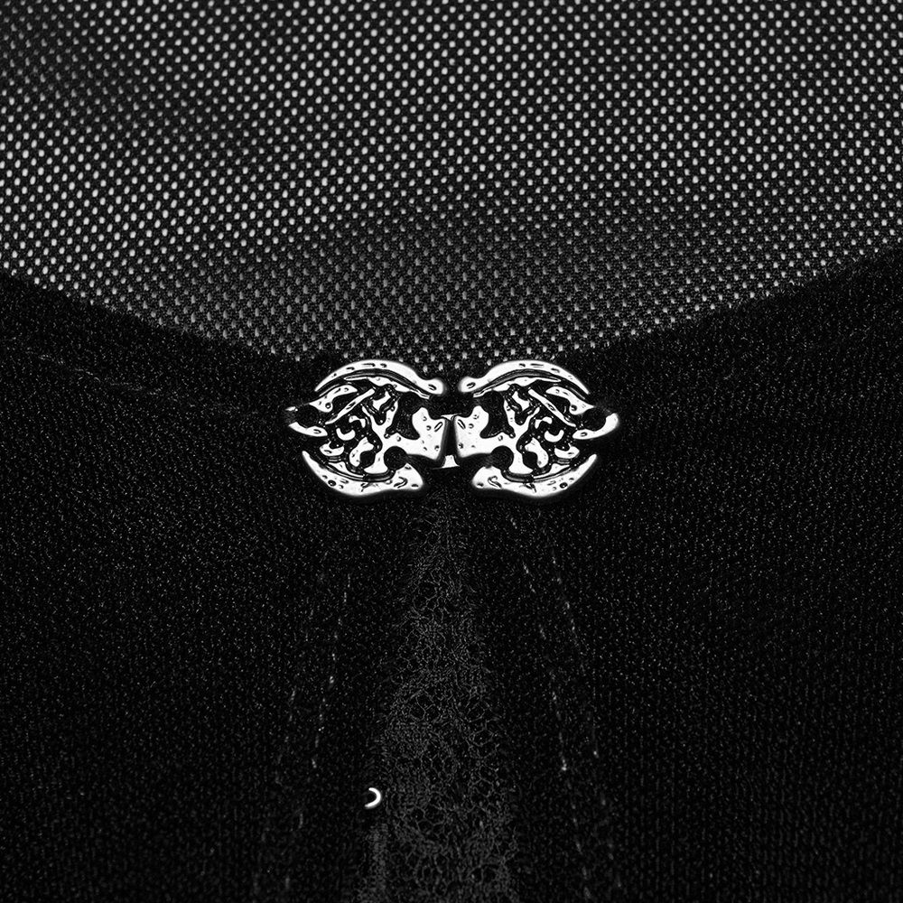 Close-up of stylish silver hook closure on a sheer black women's top with delicate detailing.