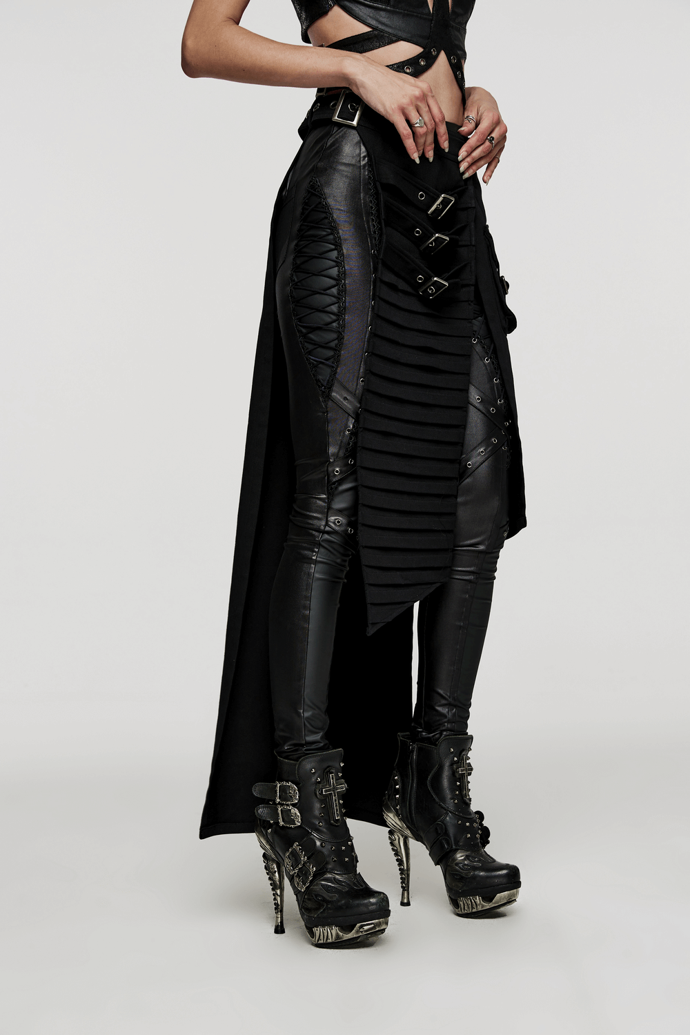 Black wrap maxi skirt with buckle accents and 3D pockets, paired with edgy heeled boots.