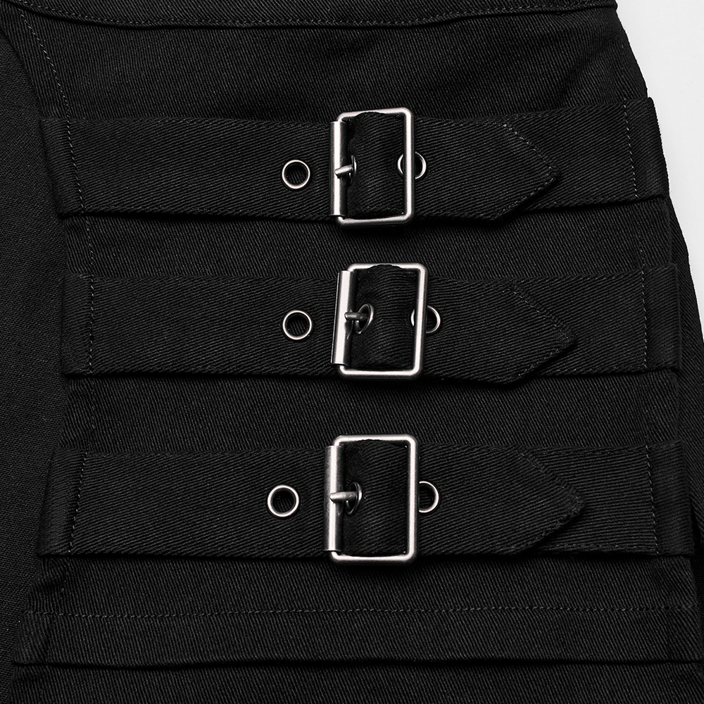 Close-up of buckle accents on a black wrap maxi skirt, showcasing stylish detailing and edgy fashion.