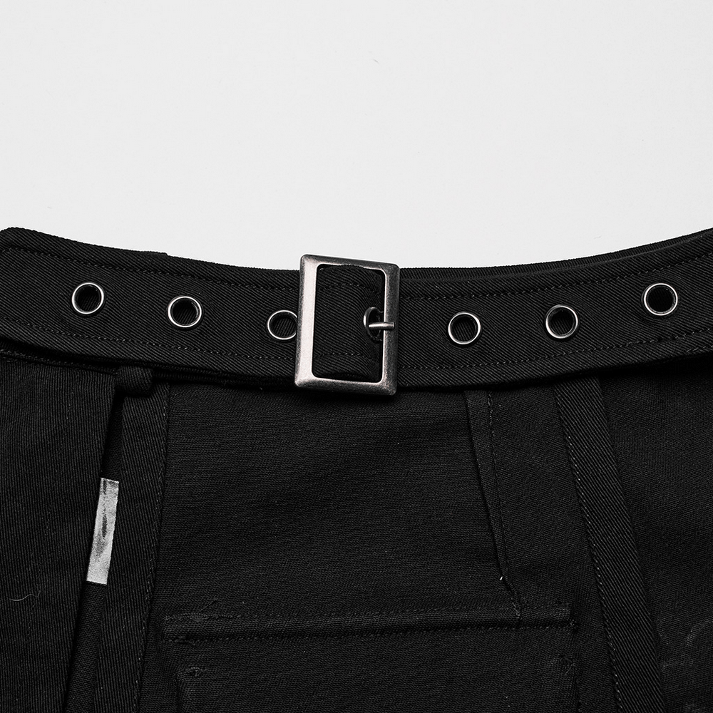 Close-up of black maxi skirt's adjustable buckle belt with silver grommets, showcasing edgy details.