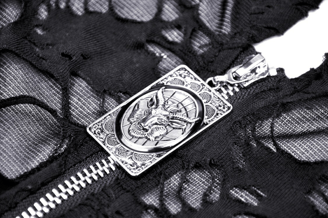 Close-up of silver zipper detail on black distressed lace coat with gothic charm and edgy design.