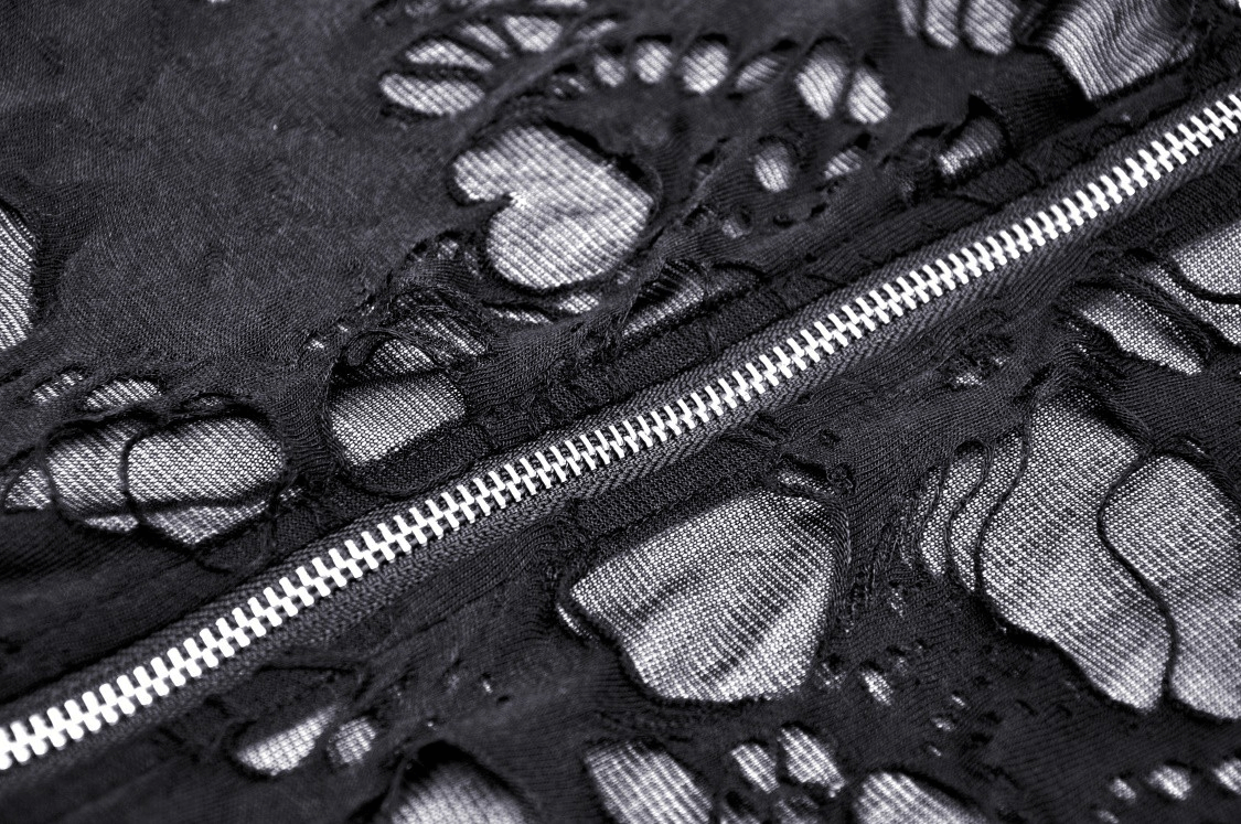 Close-up of a distressed black lace fabric with a zipper, showcasing gothic style and edgy design.