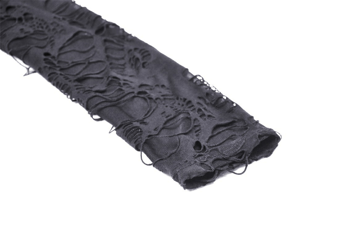 Detail of distressed black lace fabric showcasing the gothic design for a unique coat.