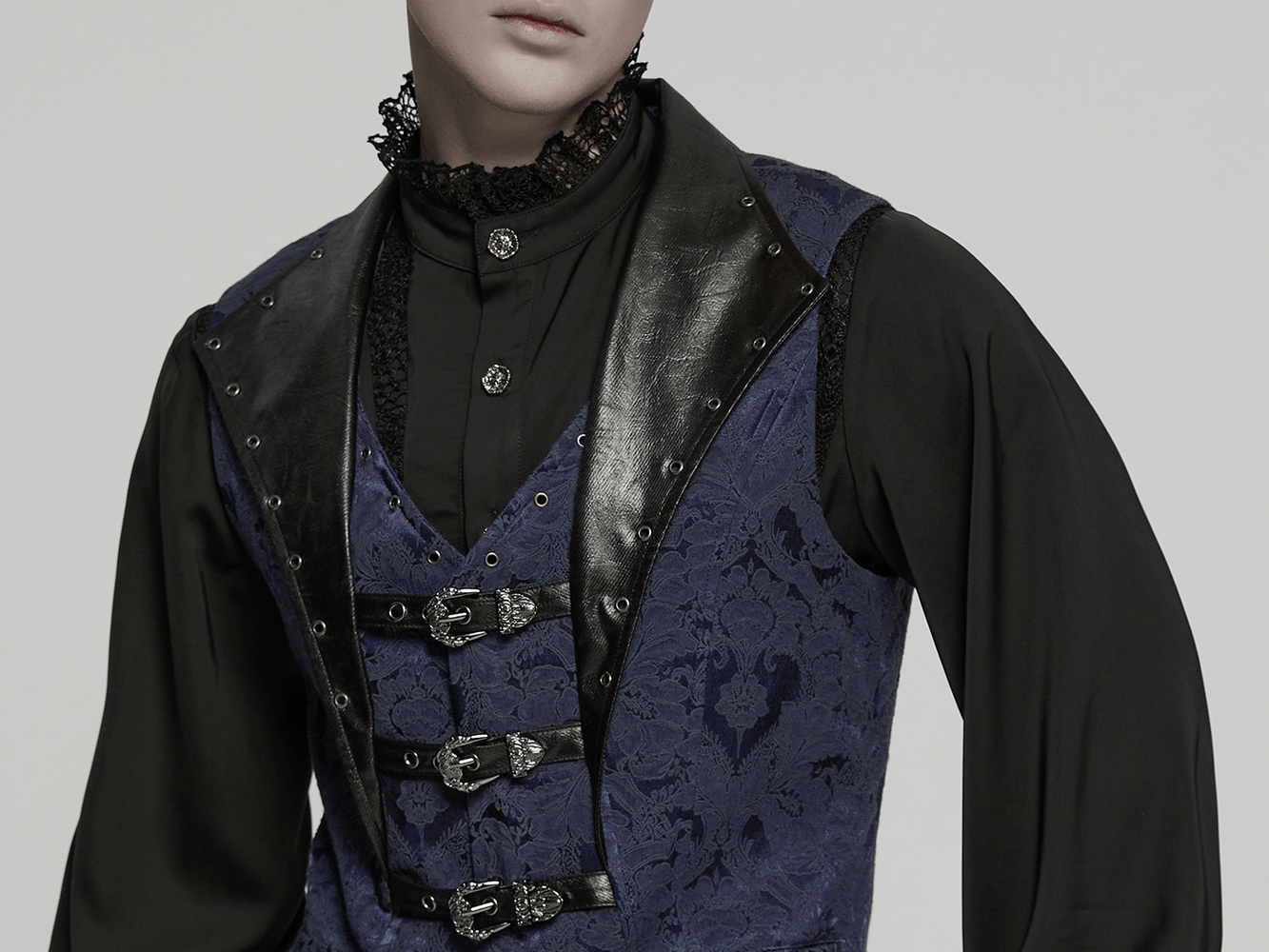 Men's blue gothic brocade waistcoat with leather lapel and buckles, featuring bat hem and unique eyelet details.