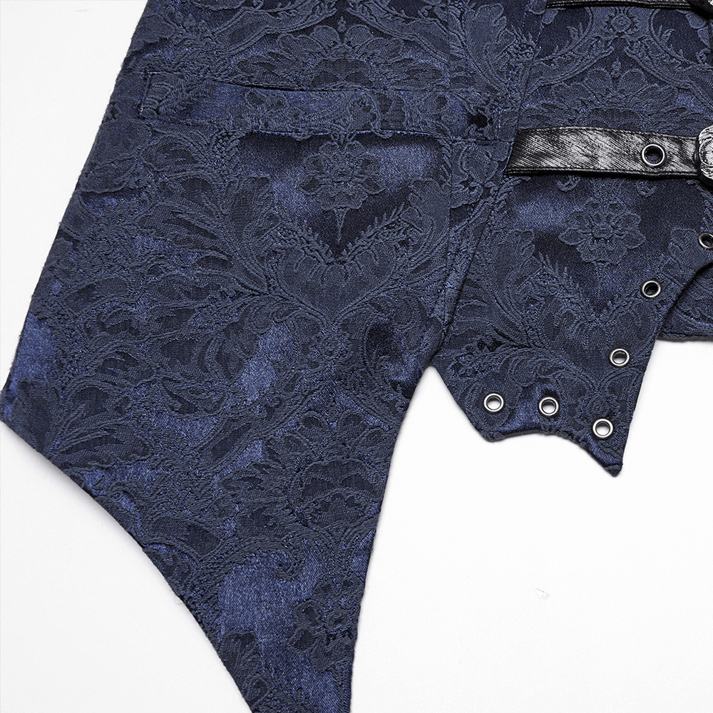 Close-up of blue gothic brocade waistcoat showcasing textured fabric and leather lapel with eyelets and bat hem.