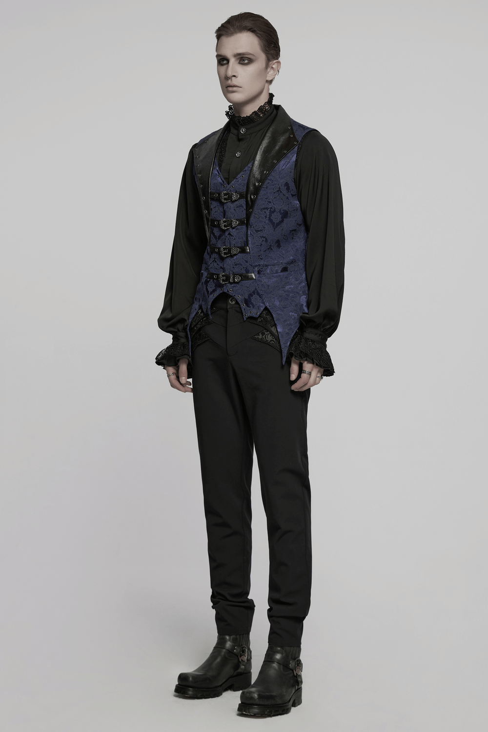 Blue gothic brocade waistcoat with leather lapel buckles, bat hem, and eyelets for a dramatic style.