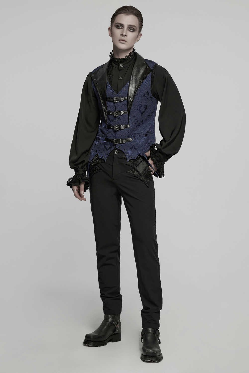 Men's blue gothic brocade waistcoat with leather lapel and buckles, styled for dark elegance.
