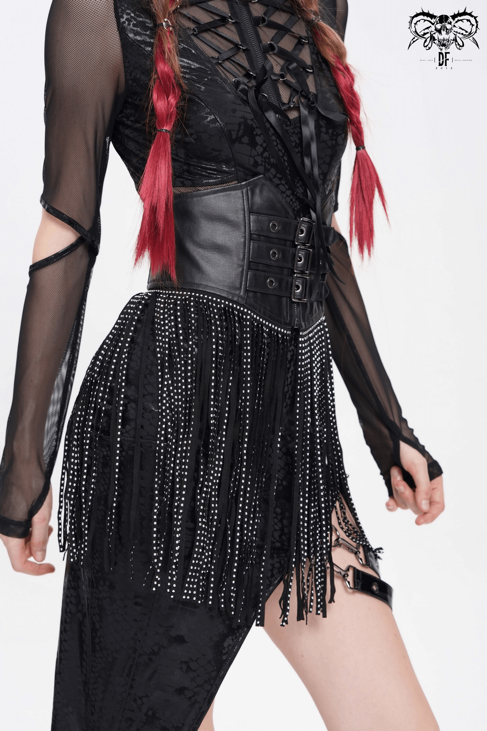 Bold black corset belt with studded fringe tassels paired with a gothic outfit, accentuating the waist and style.