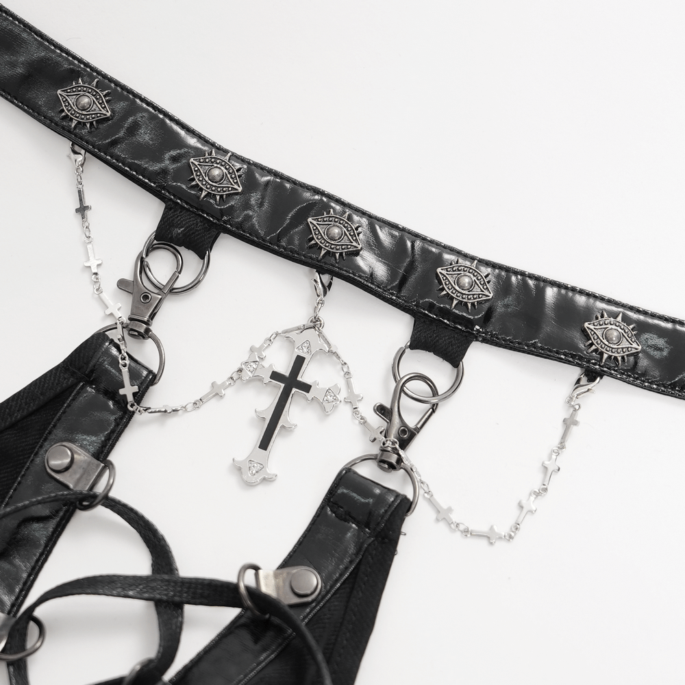 Black halter dress detailing with chains, buckles, and metallic eye designs for a punk rock aesthetic.